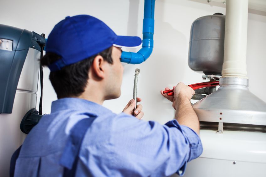 15271669 - plumber repairing an hot-water heater 15271669 - plumber repairing an hot-water heater