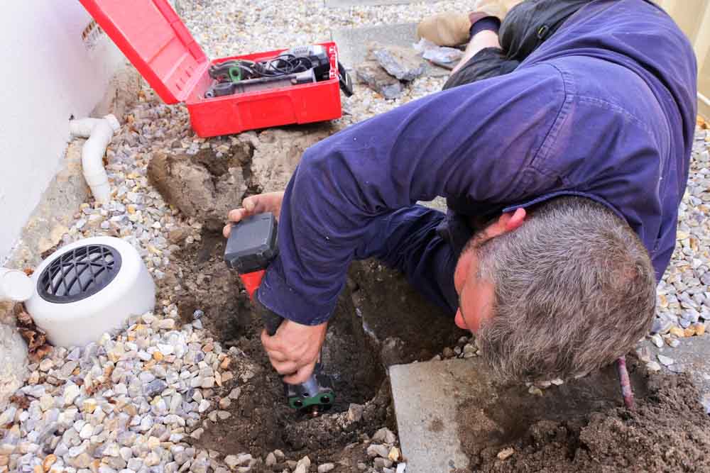 plumber fixing an underground hot water pipe leaking