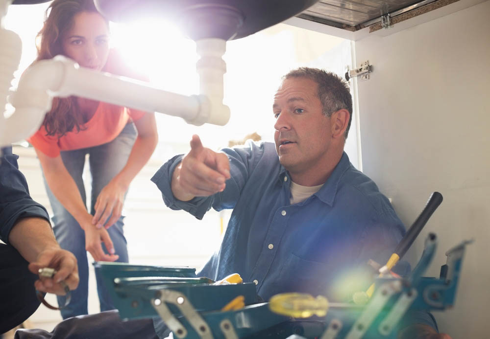 a plumber inspecting a pipe