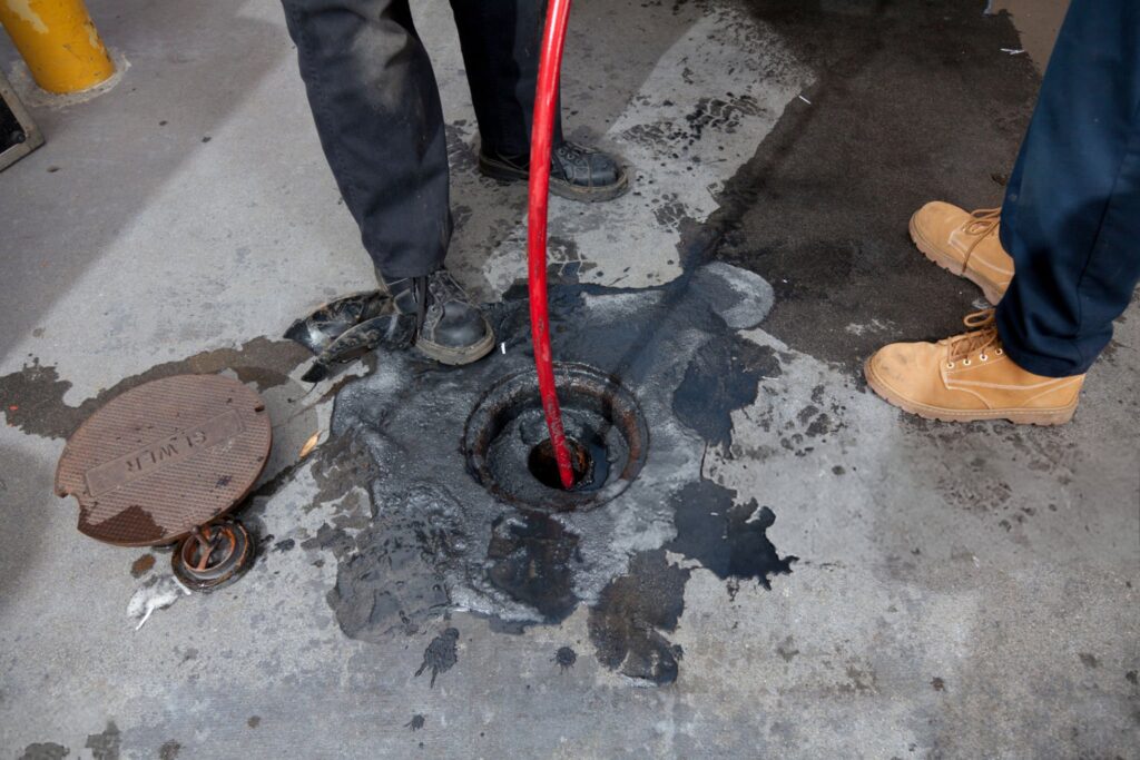 Commercial plumbers hydro line jet a pipe at a large restaurant