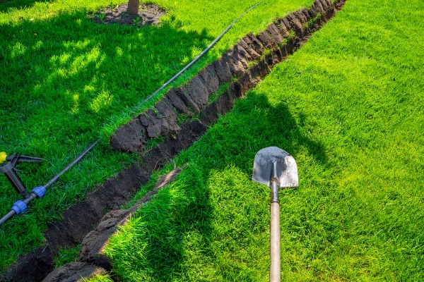 trench dug for lawn irrigation pipe