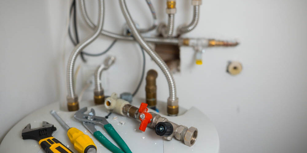 plumbing tools beside a water heater