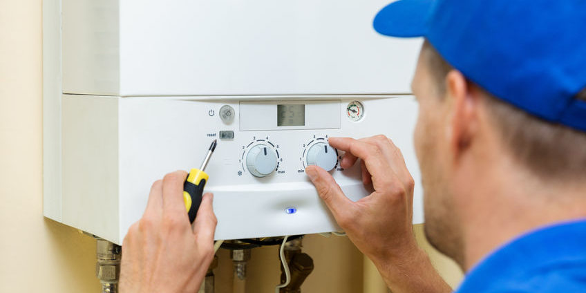 worker set up central gas heating boiler at home worker set up central gas heating boiler at home